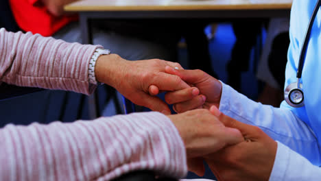 Mid-section-of-female-doctor-consoling-sad-disabled-senior-woman-at-nursing-home-4k