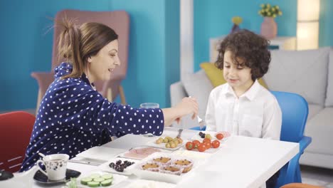 Happy-mother-and-son-having-breakfast-at-home.-Happy-family-portrait.