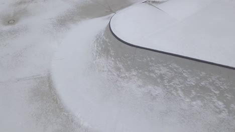 Part-of-a-concrete-skatepark-covered-with-light-snow