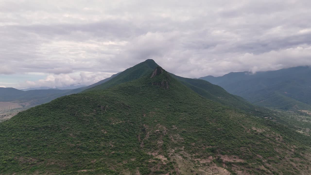 Aerial View of Lush Green Mountains on a Cloudy Day