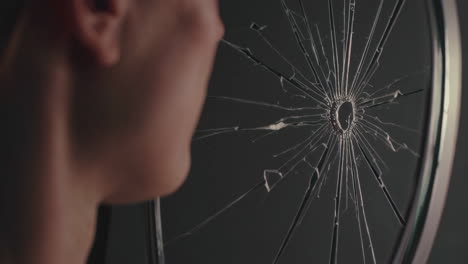 person looking at a broken mirror