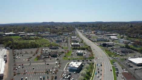 4k aerial drone footage of industrial shopping centers and strip malls in middletown new york and traffics can be seen with mountains in the background