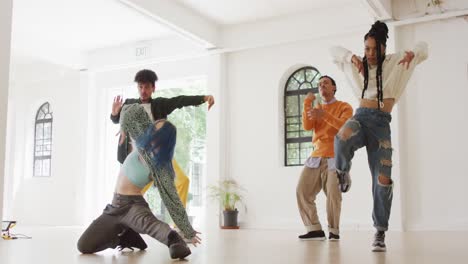 happy diverse male and female dancers dancing in dance studio, slow motion