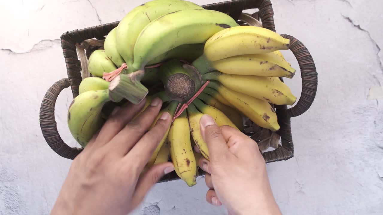 바구니 에서 바나나 를 뽑는 손