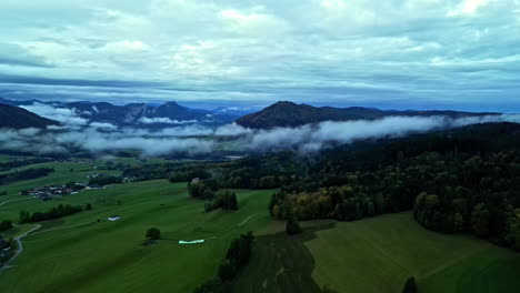 Low-Foggy-Clouds-Floating-Over-Trees-And-Mountains-Near-Rural-Village