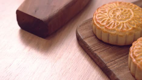 baked cantonese moon cake pastry on a wooden tray for traditional chinese mid-autumn festival.