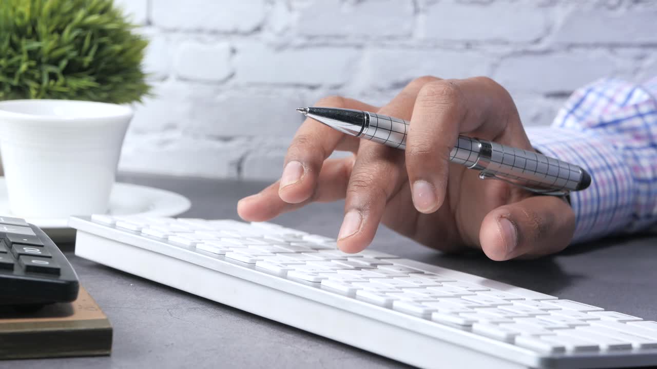 Person typing on a keyboard