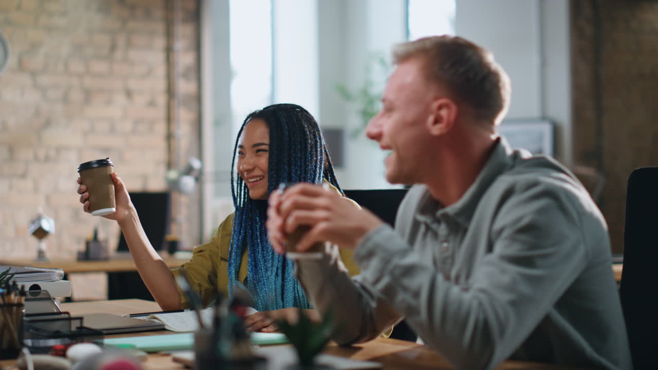 Friendly colleagues talking work break sitting modern office workplace close up.