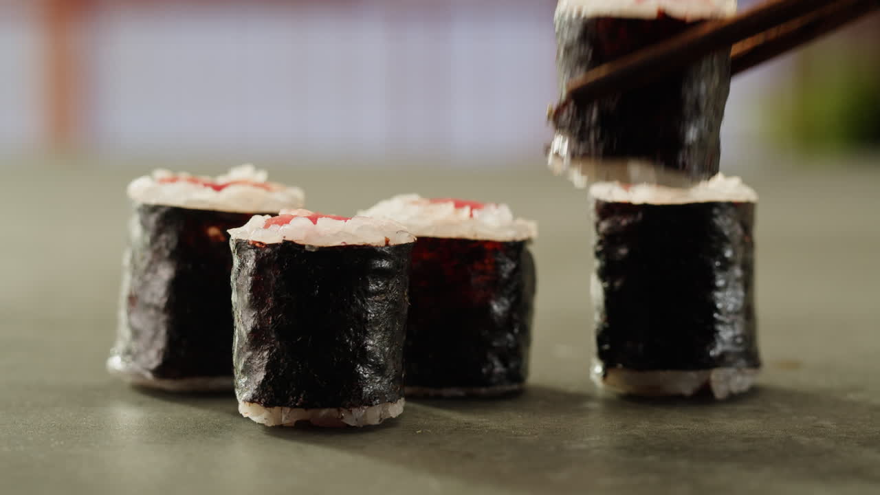 primer plano de rollos de sushi con palillos