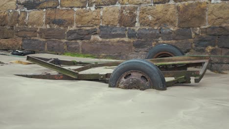 boat trailer sunk in sand at harbor beach