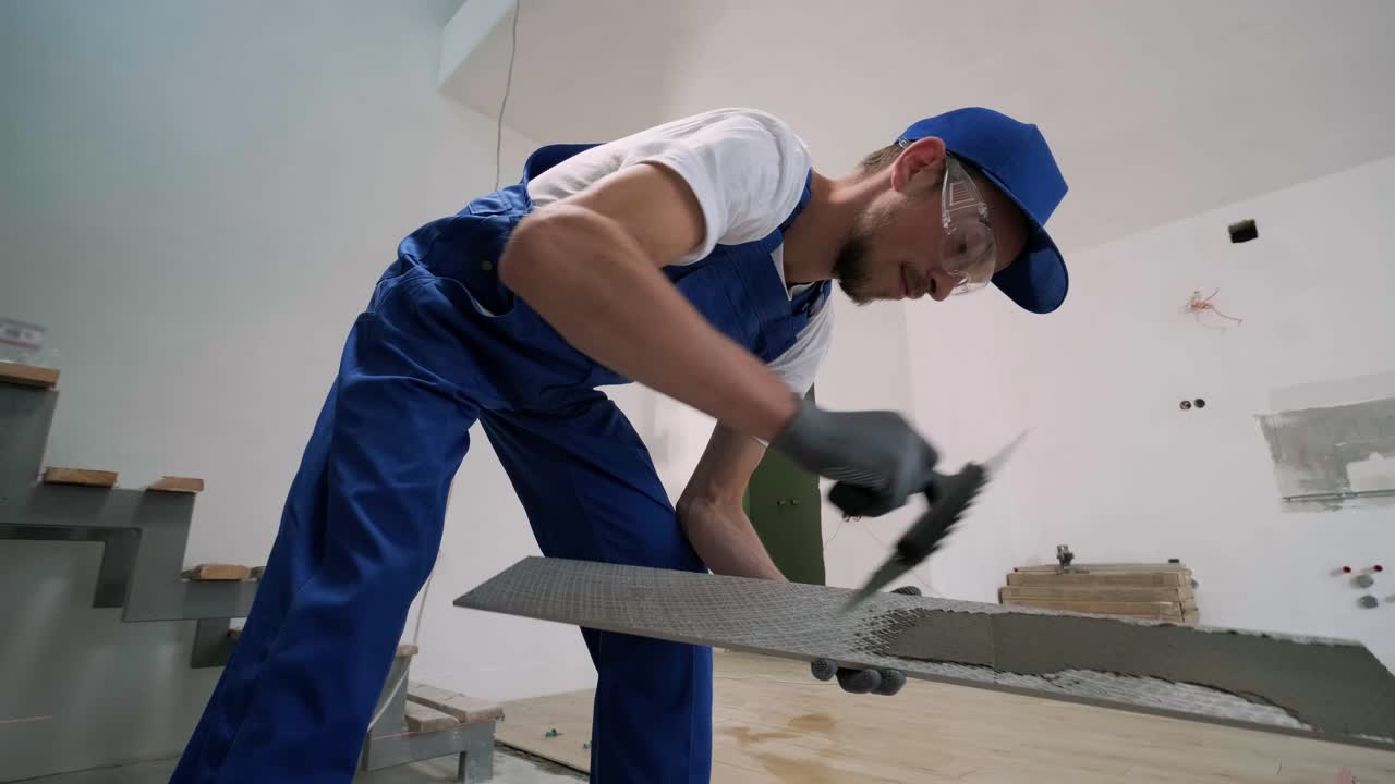 Installing ceramic floor tiles - measuring and cutting the pieces. Construction, renovation, repair apartment. Cuts tile. Tile cutting