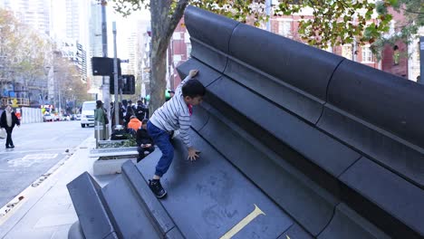 children climbing a large urban sculpture in melbourne