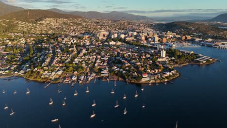 moored boats on the waters of hobart city in tasmania, australia, drone shot
