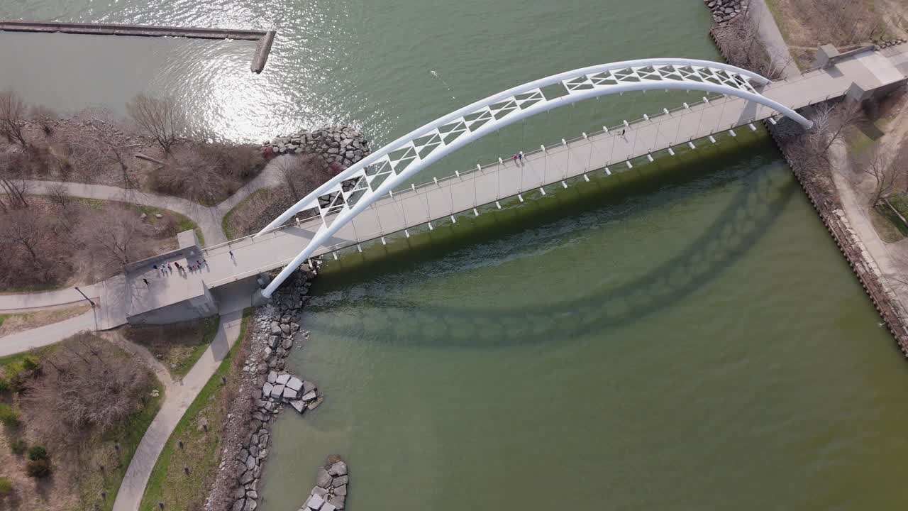 Aerial of Humber Bay Arch Bridge by Park Lawn over Lake Ontario in Toronto