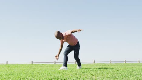 Video-of-happy-african-american-boy-doing-cartwheel-outdoors