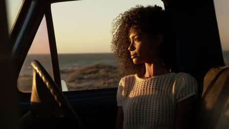 Woman-sitting-in-pickup-truck-at-beach-4k