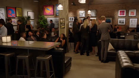 lively social event at a bar with dj and art