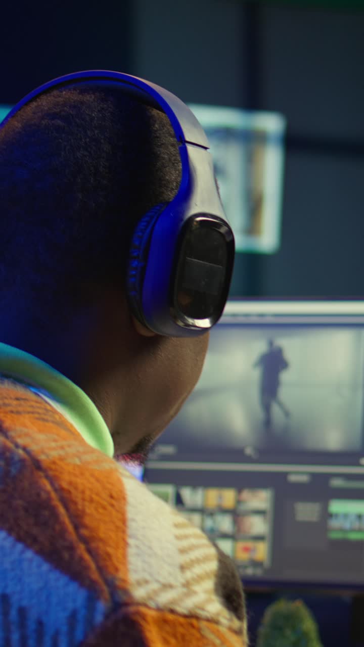 Vertical Video Videographer expert adjusting movie clips on computer at his home