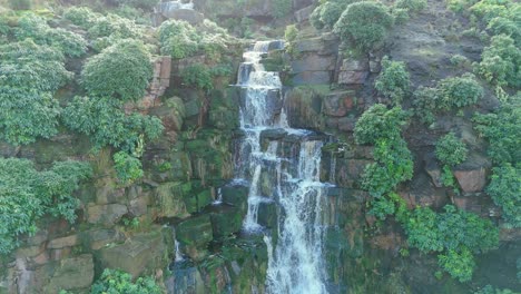 Aerial-drone-footage-of-a-tall-rocky-waterfall-in-the-Yorkshire-Dales,-Pennies