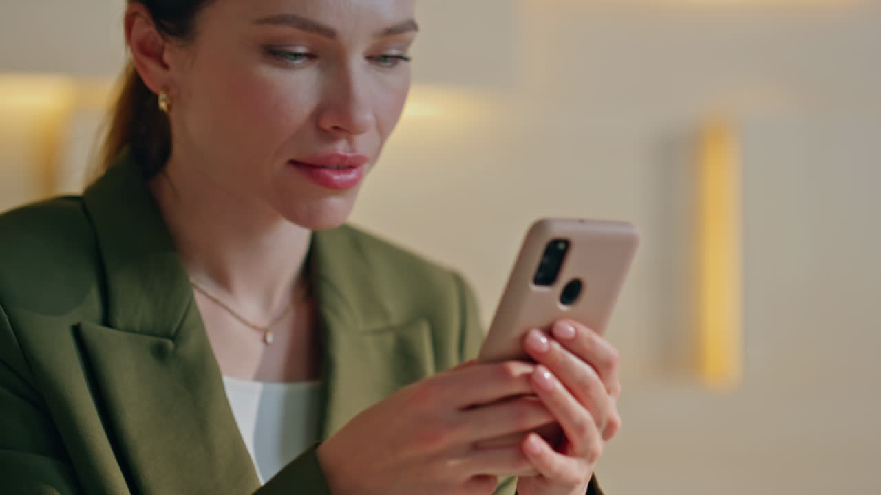 Businesswoman texting mobile phone in workplace close up. Woman messaging phone