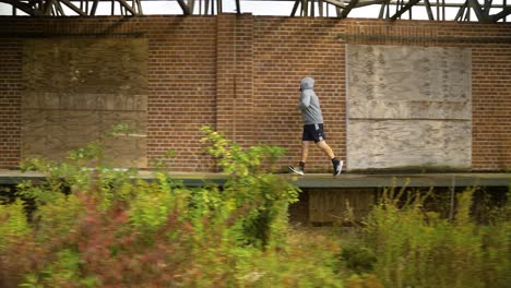 a man incorporating running into his training regimen - tracking shot
