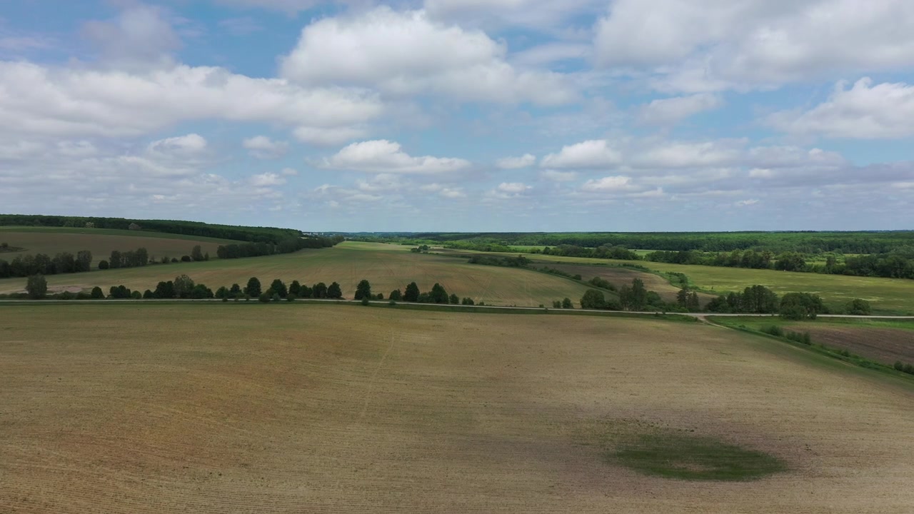 Aerial View of Vast Agricultural Fields and Rolling Landscape
