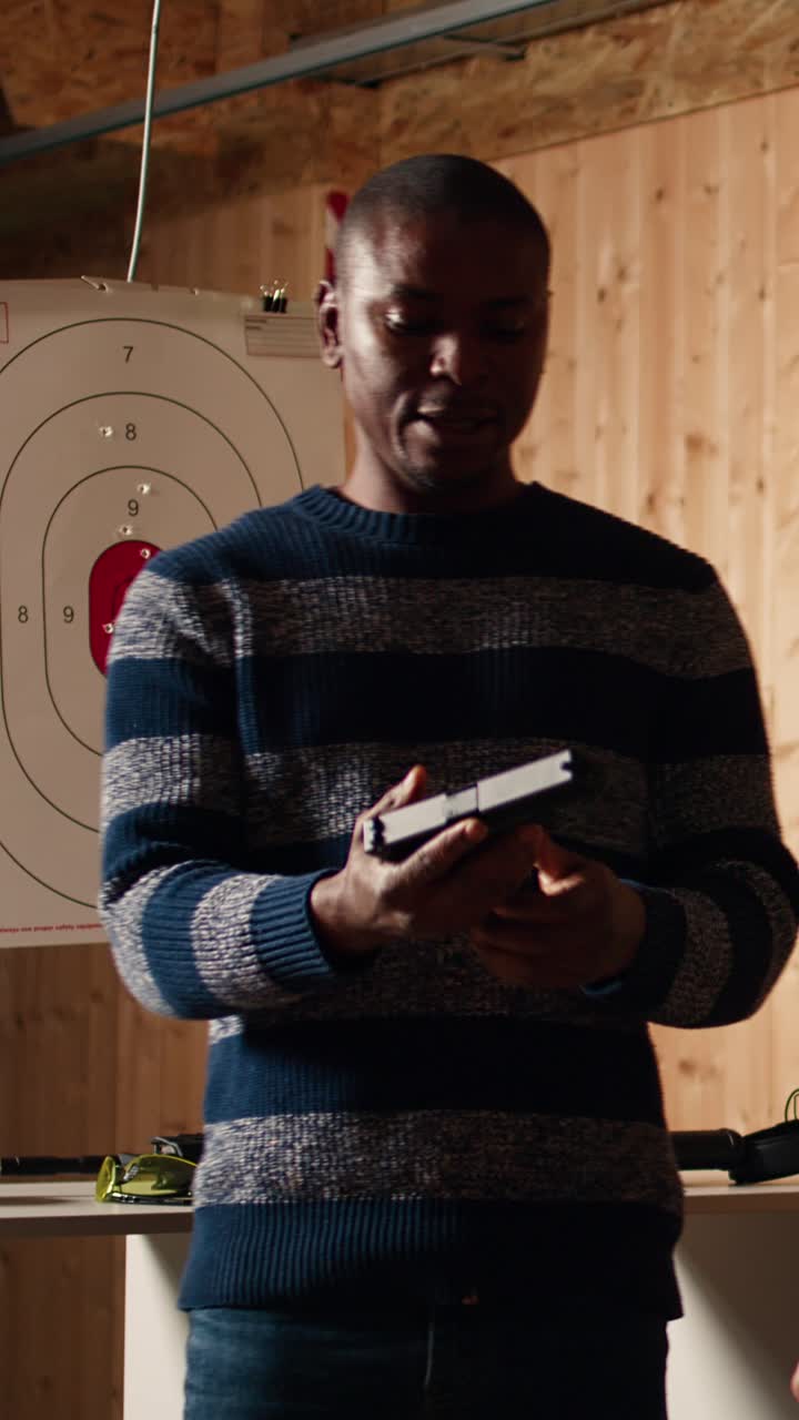Vertical video Shooting gallery expert demonstrating how to safely reload pistol and cock gun