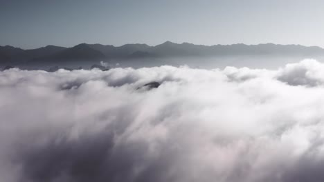 Aerial:-amazing-Xianggong-Mountain-peaks-above-low-clouds,-China