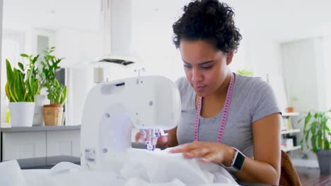 Woman-stitching-clothes-on-sewing-machine-4k