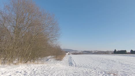 Ride-down,-sliding-on-sledges-in-countryside,-snowy-winter,-pov,-slow-motion