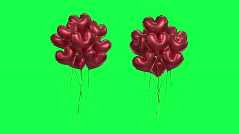 bundle of red heartshaped balloons on a green background