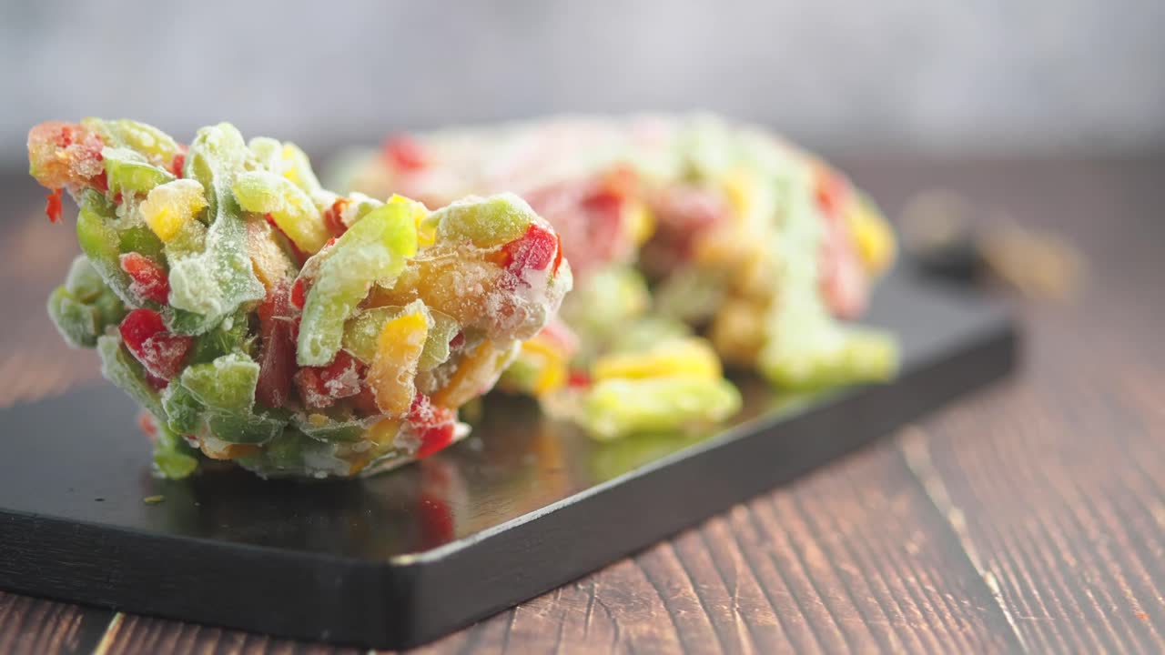 Close-up of frozen mixed bell peppers on a cutting board
