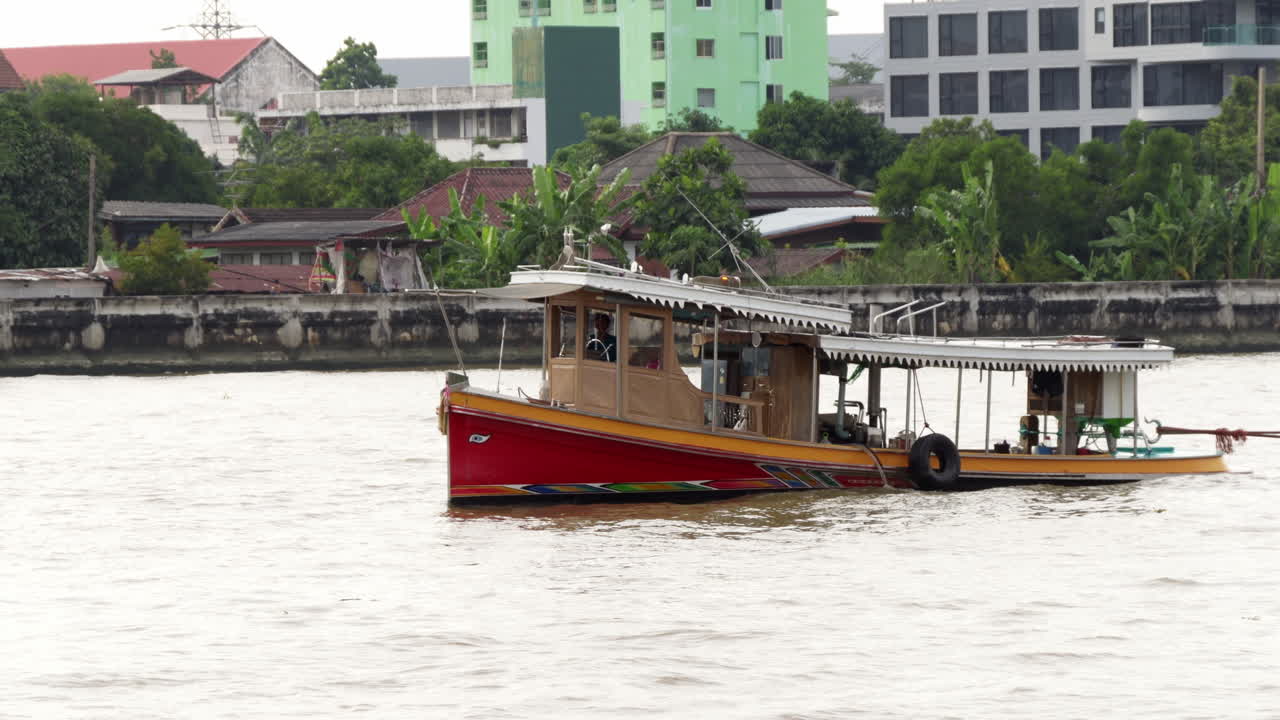 Red and Yellow Tugboat on a River in Thailand