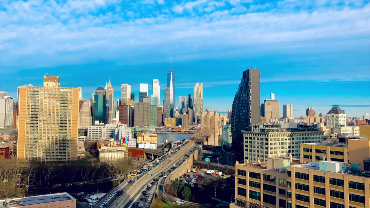 Daytime timelapse of Brooklyn Bridge with Lower Manhattan skyline, traffic, and city movement in NYC