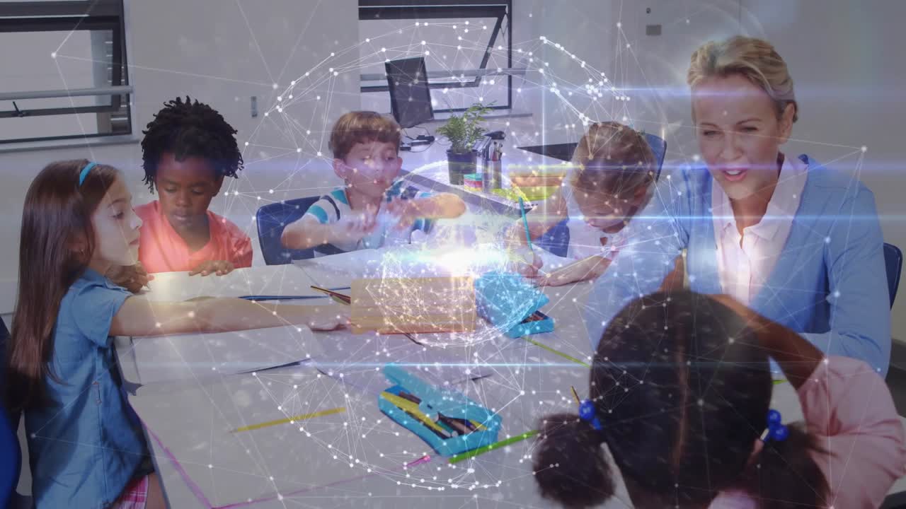 Naisopettaja ohjaa oppilaita ottamaan sinistä osaa STEM-sarjalaatikosta digitaalisen pallon sykkiesessä.