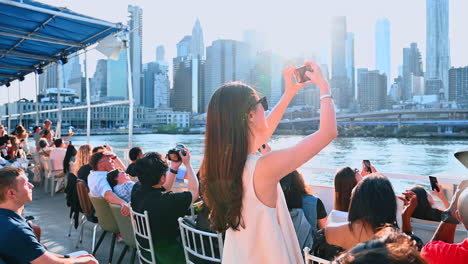 new york - august 2014: cruise yacht with manhattan skyline in the background on august 11, 2014. manhattan is the central part of nyc. it is one of the worlds leading cultural and economic centers
