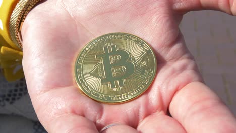 putting a bitcoin in the palm of the hand