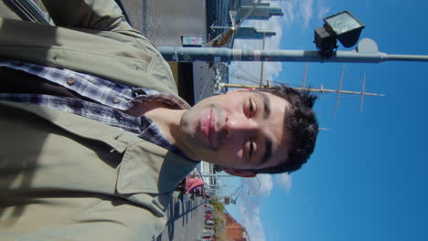 blogger showing city and talking on camera outdoors