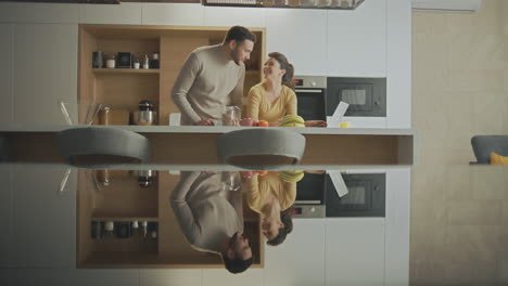 happy couple enjoying breakfast in modern kitchen