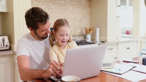 smiling father sitting on chair assisting his daughter with laptop 4k 4k