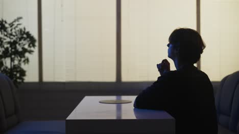 person sitting at table at night