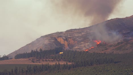 a wildfire burns out of control in the california hills