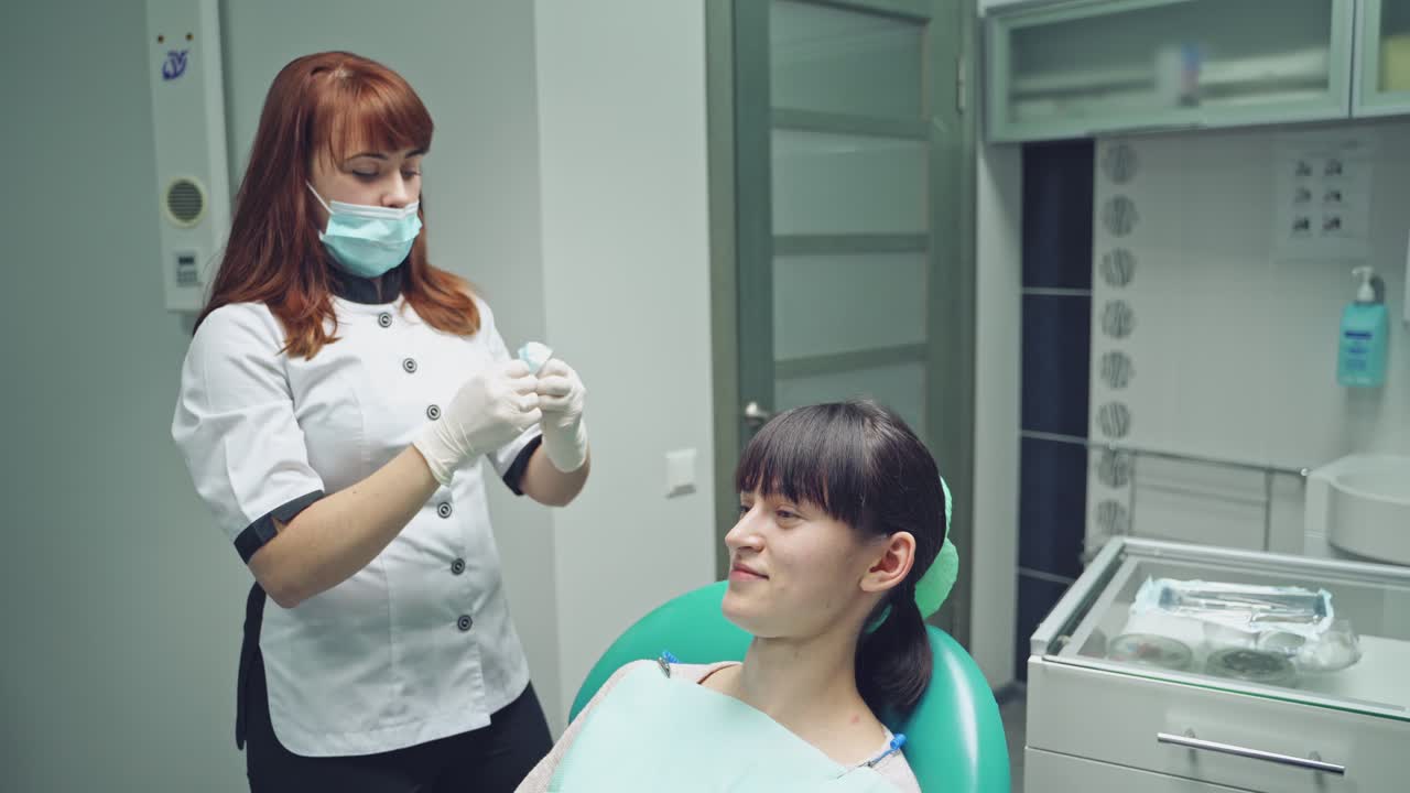 Woman at the dentist smiling. Work of stomatologist with patient. Make your smile perfect.