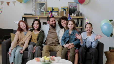 family and guests posing at home