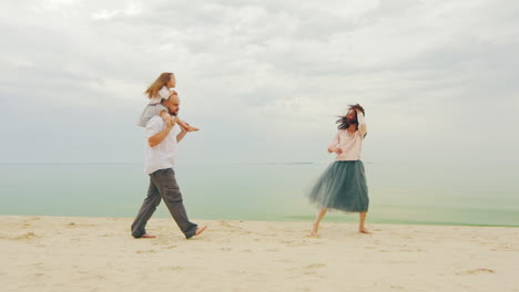 Happy-Family-Of-Three-People-Running-On-The-Beach-02