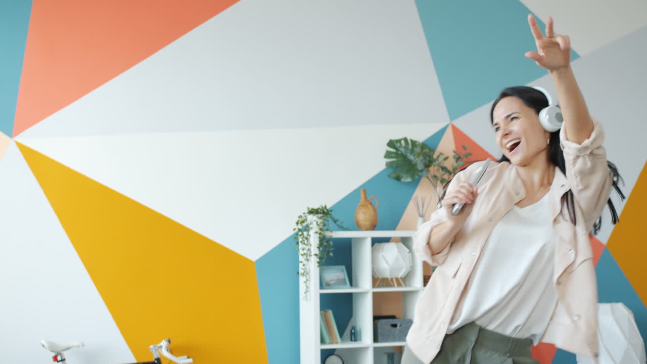 Woman Singing and Dancing in a Colorful Living Room