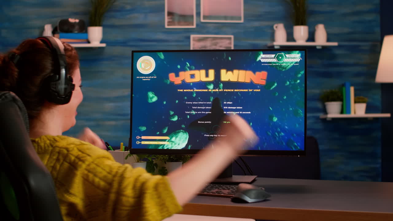 Back view of happy pro gamer winning space shooter game