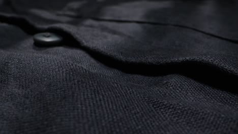 close-up view of dark linen fabric with button