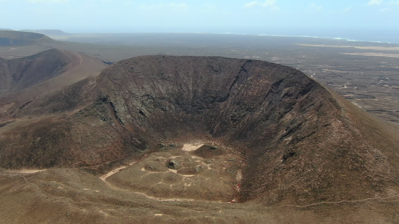 Aerial drone panning right to left video footage of the Calderón Hondo volcano in Fuerteventura island