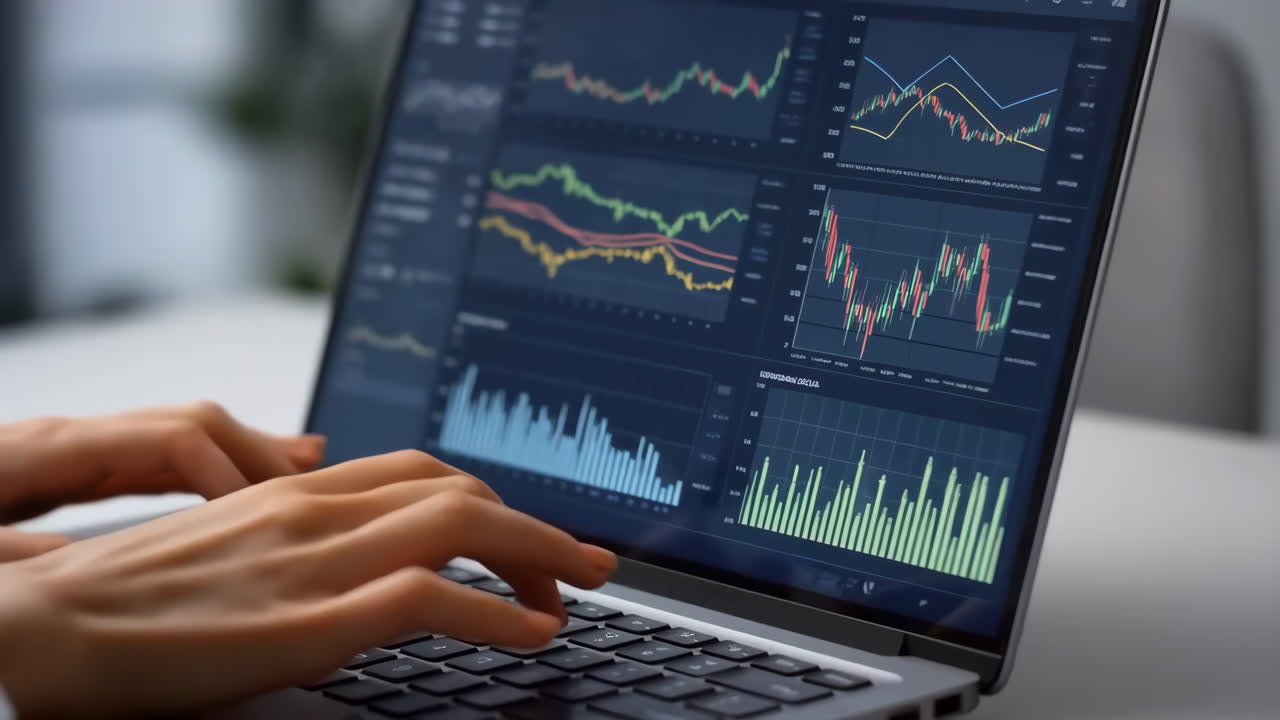 Person using laptop for stock market analysis